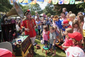 Uncle Tacko Flea Circus outdoors with crowd and bunting